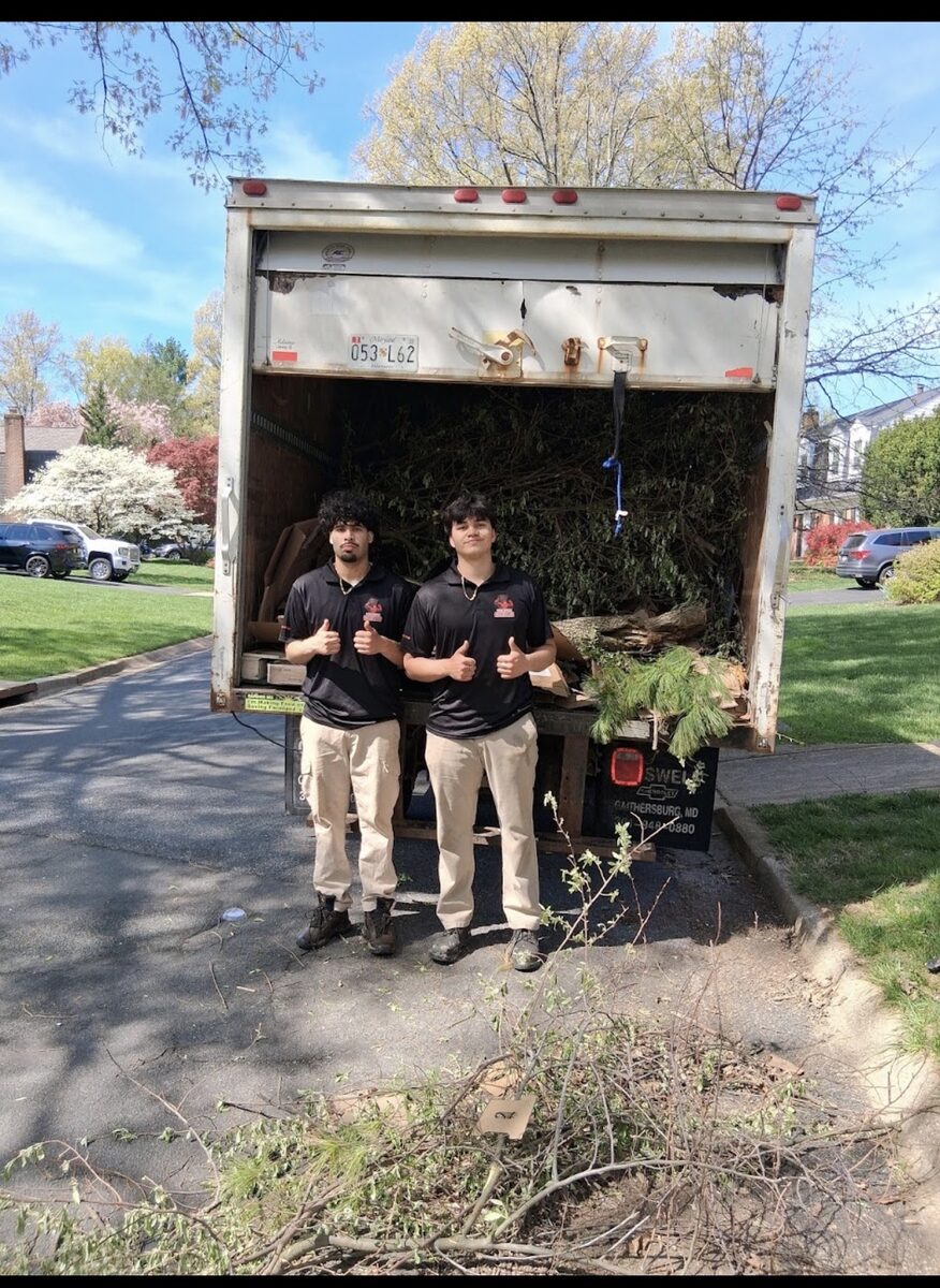 Two crew members after yard waste removal job